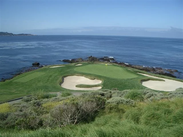 The small coastal seventh green at Pebble Beach above the Pacific Ocean